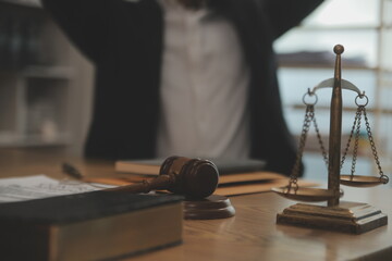 Judge gavel with Justice lawyers having team meeting at law firm background. Concepts of Law and Legal services.