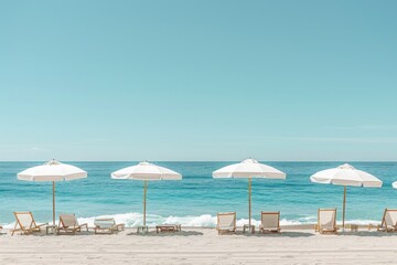 A beach scene with four white umbrellas and several chairs
