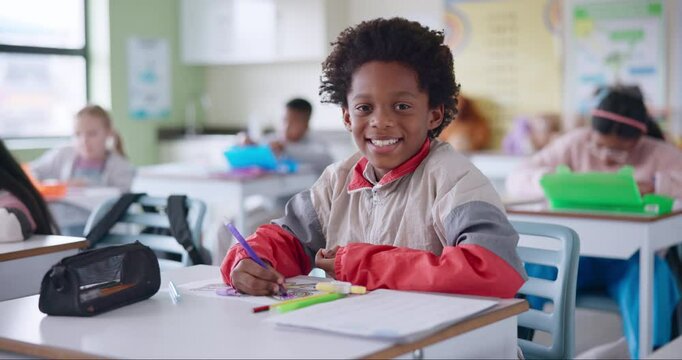 African boy, face and student in classroom with creative learning, skills development or coloring for school activity at desk. Portrait of smart, intelligent and confident or happy child in education