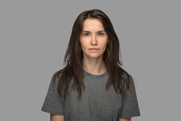 Portrait of a young woman in a white T-shirt. No make up, neutral