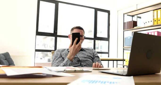Dissatisfied businessman cant reaching client on mobile phone in office 4k movie. Problems and difficulties of remote business concept