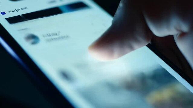 Close up of a Person scrolling through a social media feed on a smartphone