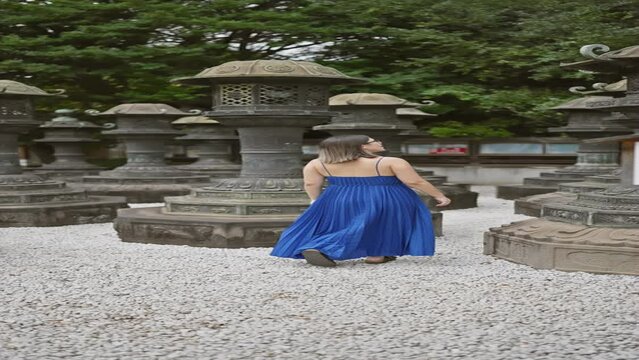 Captivating view of a beautiful hispanic woman in glasses, captured in a casual walk away from ueno park's renowned temple, her brunette hair bouncing with every step.