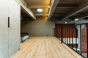 The hallway is distinguished by luxurious hardwood flooring and an elegant handrail that leads to a bedroom, combining opulence and practicality in the homes interior design