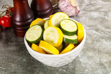 Sliced raw young green and yellow zucchini