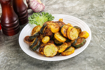 Roasted young zucchini in the plate