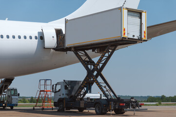 The tail of a passenger airliner with an open door. Special transport delivered the cargo in a...