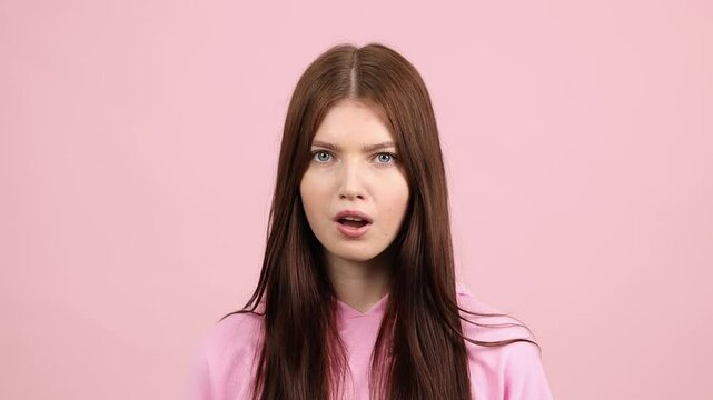 Surprised woman on pink, slow motion