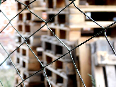 grid on a blurred background of a pile of pallets. Pattern of Old wood pallet pile texture background