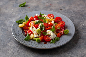 healthy colorful tomato mozzarella basil salad with balsamic vinegar dressing