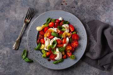 healthy colorful tomato mozzarella basil salad with balsamic vinegar dressing