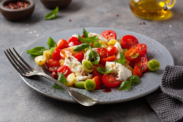 healthy colorful tomato mozzarella basil salad with balsamic vinegar dressing