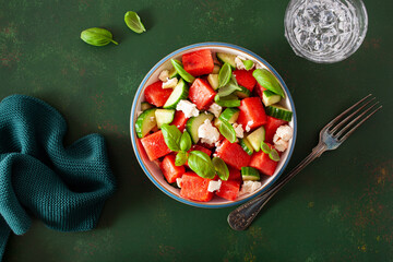 watermelon salad with feta cheese, cucumber and basil. healthy summer dessert