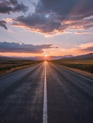 Fototapeta premium sun rising at the end of a long, empty road