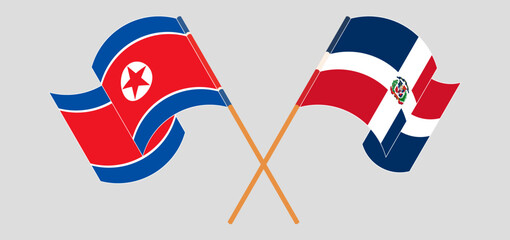 Crossed and waving flags of North Korea and Dominican Republic
