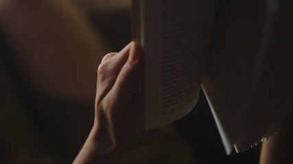 woman hands holding a novel book turning the pages in slow motion 
