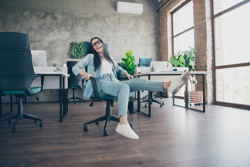 Full body photo of attractive woman ride armchair dressed denim clothes executive business leader work comfort beautiful office interior