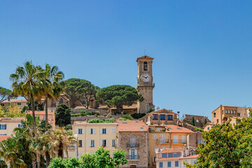 Discover a Mediterranean village with a clock tower, colorful houses, and a peaceful ambiance. Cannes, French Riviera, France.