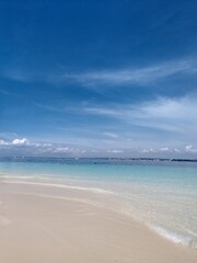 the sea under a blue cloudy sky. Beach, summer, clean blue water