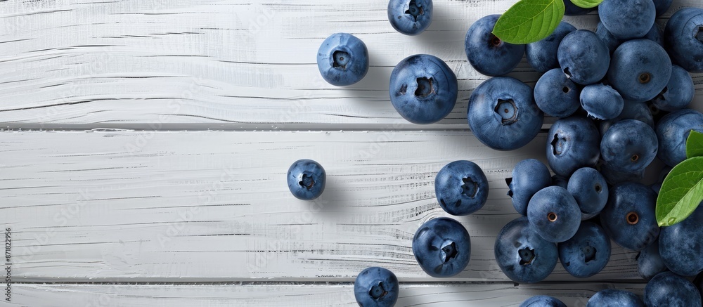 Poster blueberries on a white wooden surface, symbolizing healthy eating with antioxidants. ideal for websi