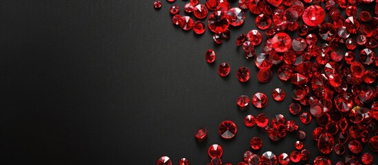 Black background adorned with vibrant red glass beads, ideal for a copy space image.