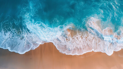 Panoramic view of a sandy beach from above. The waves gently roll onto the shore.