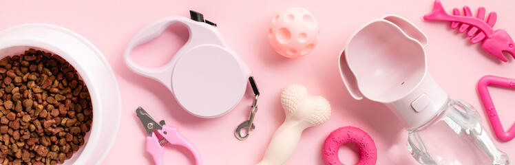 Pet shop banner design with pet care items on pink background. Top view bowl of dry food, leash,...