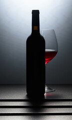 Bottle and glass of red wine.