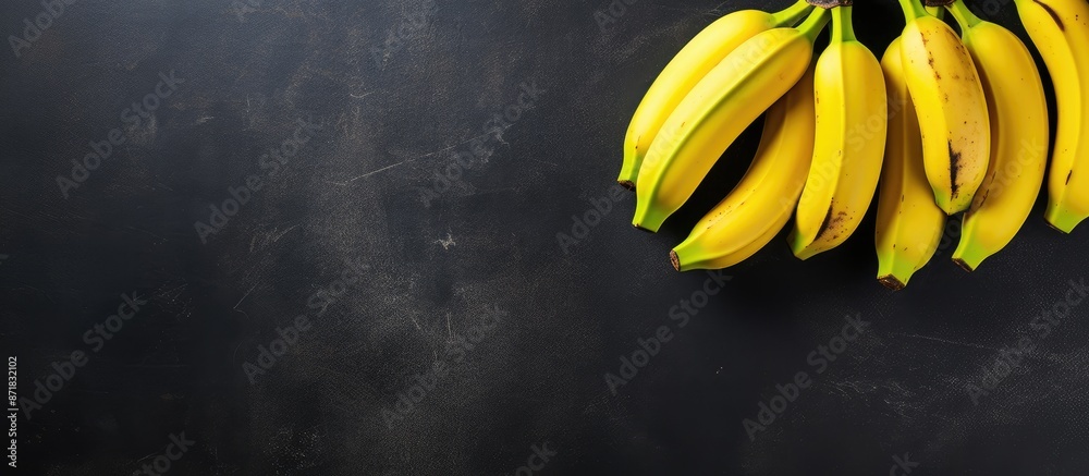 Poster Aerial perspective showing four bananas on a dark slate surface with copy space image to the right.
