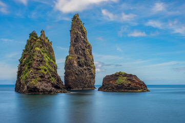 Naklejka premium Baía de Alagoa on the island of Ilha das Flores, Azores, Portugal. Atlantic ocean coastline. Stones, rocks and water in long exposure. Nature photography in motion.