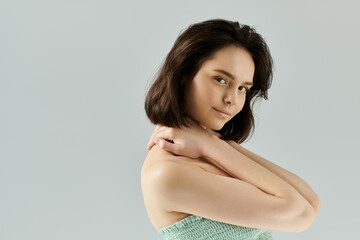 Fototapeta premium A portrait of a beautiful woman posing in a studio with soft lighting.