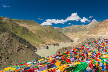 Buddhist prayer flags hanging from an unidentified peak over Smira La-mountain pass at 4200...