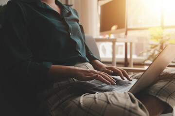 Obraz premium Distracted from work worried young woman sitting on couch with laptop, thinking of problems. Pensive unmotivated lady looking at window, feeling lack of energy, doing remote freelance tasks at home.