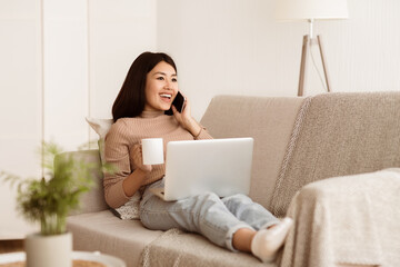 Girl Talking on Phone, Enjoying Morning Coffee and Using Laptop at Home, Copy Space