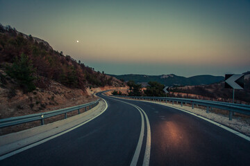 Serpentine road at night.