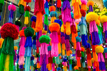 Fototapeta premium Decorations hanging colored jellyfish made from woolen threads and pompom balls suspended on the ceiling