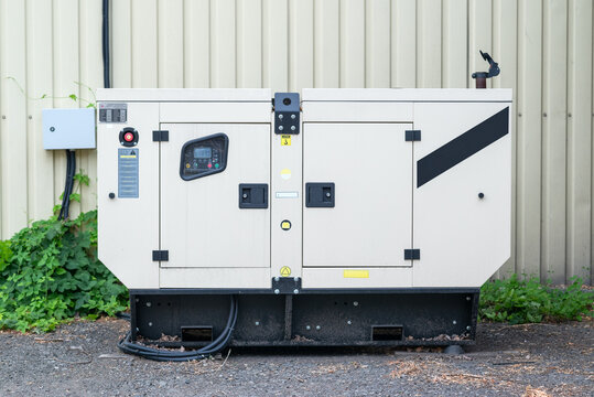 auxiliary diesel generator for emergency power supply. Industrial generator connected to the control panel by a cable wire. Backup power supply of the generator	
