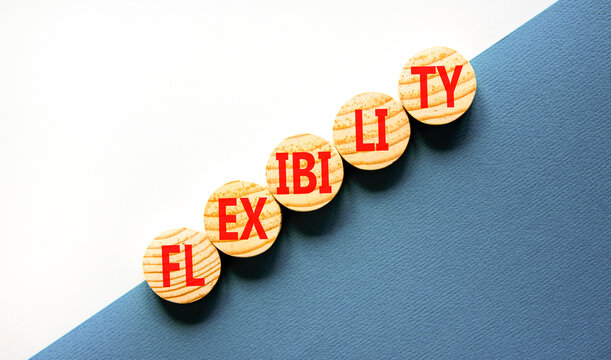 Flexibility symbol. Concept word Flexibility on beautiful wooden circles. Beautiful white and blue background. Business flexibility concept. Copy space.