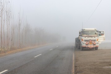 Truck Parked in Dense Fog on a Roadside in Swat Valley