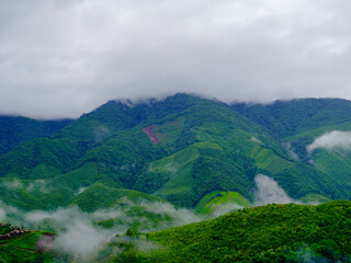 Aerial view of the beautiful Sapan village scenery, a small village in the middle of a valley surrounded by nature during the rainy season at Nan Province, Thailand.