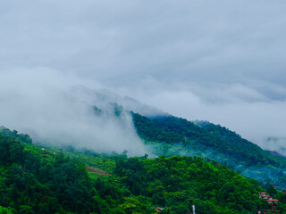 Aerial view of the beautiful Sapan village scenery, a small village in the middle of a valley surrounded by nature during the rainy season at Nan Province, Thailand.