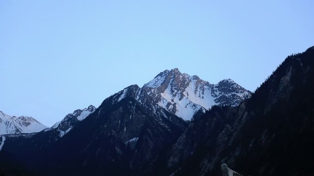 Sunset over the snow-capped mountains of Jiuzhaigou, Aba Prefecture, Sichuan Province, April 26, 2023