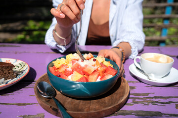 Fruit bowl with papaya, watermelon, melon with natural yogurt and granola. Vegetarian food. High quality photo