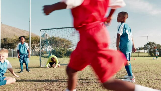 Kick, football player and children in stadium for score, practice and exercise for sport competition. Soccer field, goalkeeper and kids athletes for training, shooting and motor coordination for girl