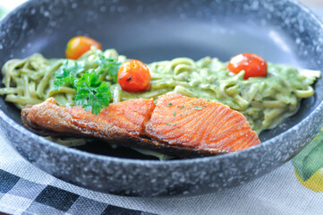 salmon pasta or pesto salmon pasta , pasta with green sauce or pesto sauce