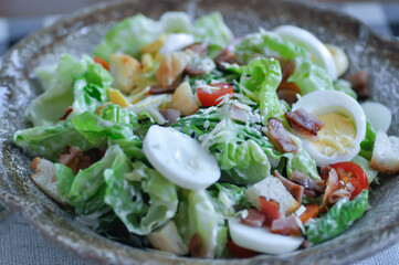caesar salad or vegetable salad with bacon , egg and Bread Croutons