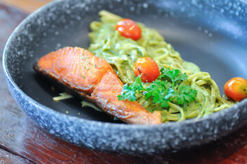 salmon pasta or pesto salmon pasta , pasta with green sauce or pesto sauce