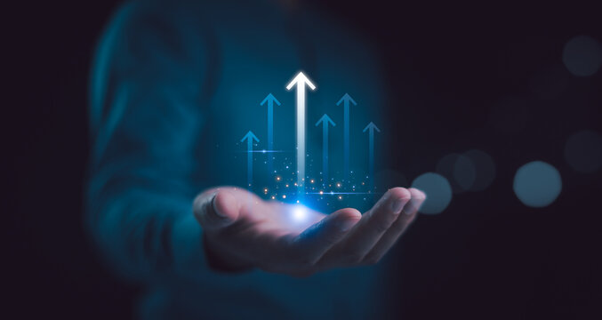 Hand holding growth business strategy arrow concept on success target improvement with increase development graph profit or economy investment income target and goal increase achievement.