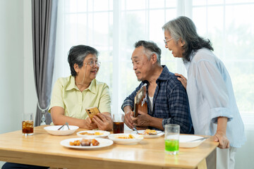 Three Senior friends bonding over music, singing and laughter in party