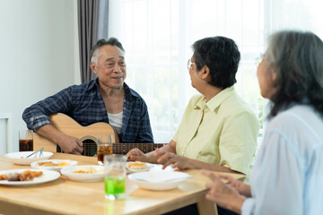 Three Senior friends bonding over music, singing and laughter in party